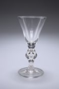 A LARGE VICTORIAN GLASS RUMMER IN THE FORM OF A GEORGIAN HEAVY BALUSTER GLASS