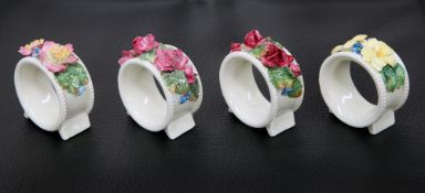 A SET OF FOUR ROYAL DOULTON NAPKIN RINGS, CIRCA 1920'S