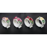 A SET OF FOUR ROYAL DOULTON NAPKIN RINGS, CIRCA 1920'S