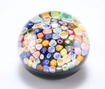 A CLOSE-PACK MILLEFIORI GLASS PAPERWEIGHT