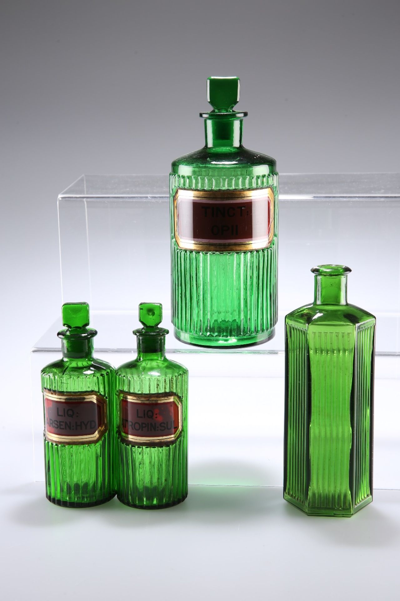 FOUR LATE VICTORIAN GREEN GLASS APOTHECARY BOTTLES