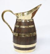 A LARGE POLISHED BRASS AND COOPERED OAK JUG