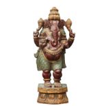 A CARVED AND PAINTED WOODEN FIGURE OF GANESH