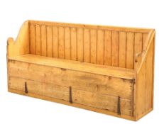 A LATE GEORGIAN IRISH PINE SETTLE BED