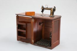A CABINET TREADLE SEWING MACHINE BY WHEELER & WILSON