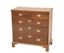 A GEORGE III OAK CHEST OF DRAWERS