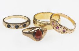 A COLLECTION OF FOUR YELLOW GOLD RINGS