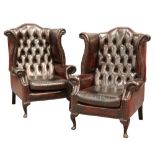 A PAIR OF BUTTON-BACK OX-BLOOD LEATHER WING CHAIRS