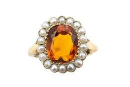 A CITRINE AND HALF PEARL RING