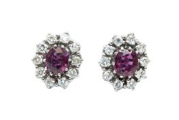 A PAIR OF RUBY AND DIAMOND CLUSTER EARRINGS