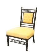AN ARTS AND CRAFTS EBONISED NURSING CHAIR