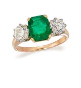 AN EMERALD AND DIAMOND THREE-STONE RING