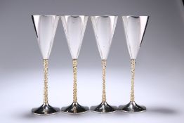 A SET OF FOUR ELIZABETH II PARCEL-GILT SILVER CHAMPAGNE FLUTES