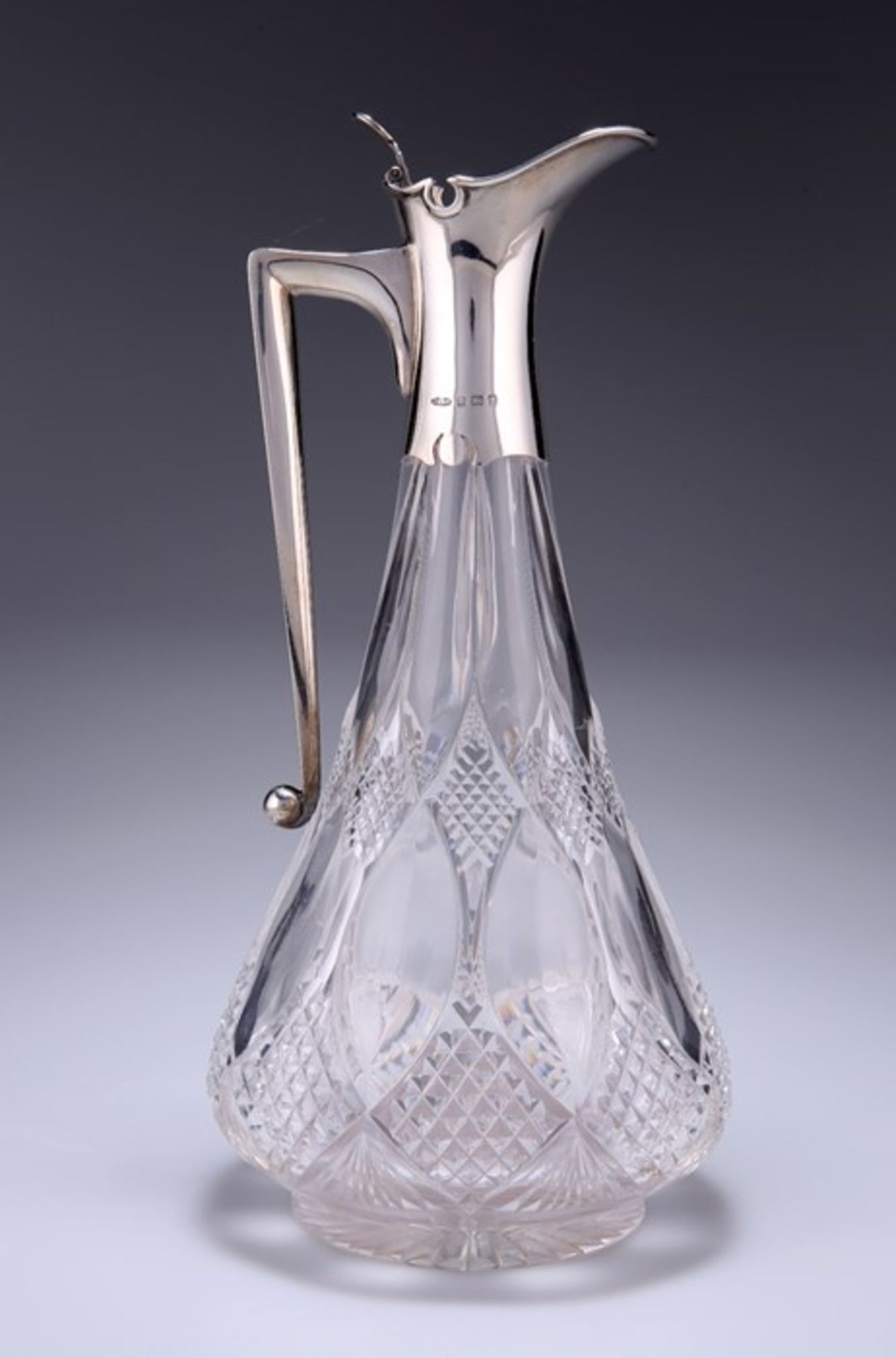 A GEORGE V SILVER-MOUNTED CUT-GLASS CLARET JUG