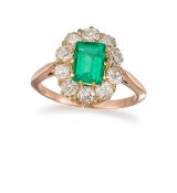 AN EMERALD AND DIAMOND CLUSTER RING