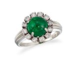 AN EMERALD AND DIAMOND CLUSTER RING