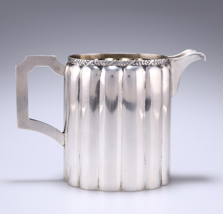 A WHITE-METAL MILK JUG