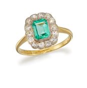 AN EMERALD AND DIAMOND CLUSTER RING