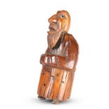 A CARVED COQUILLA NUT FIGURAL SNUFF BOX, CIRCA 1840