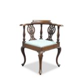 A GEORGE III STYLE MAHOGANY CORNER CHAIR