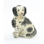 A POTTERY MODEL OF A SEATED SPANIEL. 32cm high