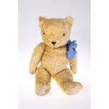 A LARGE VINTAGE TEDDY BEAR, straw stuffed. 66cm