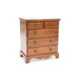 A 19TH CENTURY MAHOGANY MINIATURE CHEST OF DRAWERS