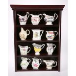 A SET OF TWELVE ROYAL WORCESTER "HISTORICAL COLLECTION" JUGS