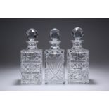 THREE LARGE SQUARE-SECTION GLASS DECANTERS.