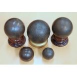 FIVE CANNON BALLS, various sizes