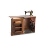 A CABINET TREADLE SEWING MACHINE BY WHEELER & WILSON