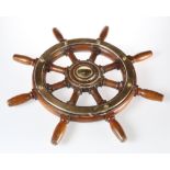 A BRASS-MOUNTED TEAK SHIP'S WHEEL, of eight-spoke design. 60.5cm