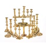 A GROUP OF SIXTEEN BRASS CANDLESTICKS, 19TH CENTURY AND LATER