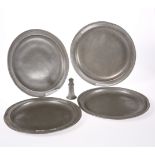 FOUR LATE 18TH CENTURY PEWTER PLATES, together with A PEWTER PEPPERETTE