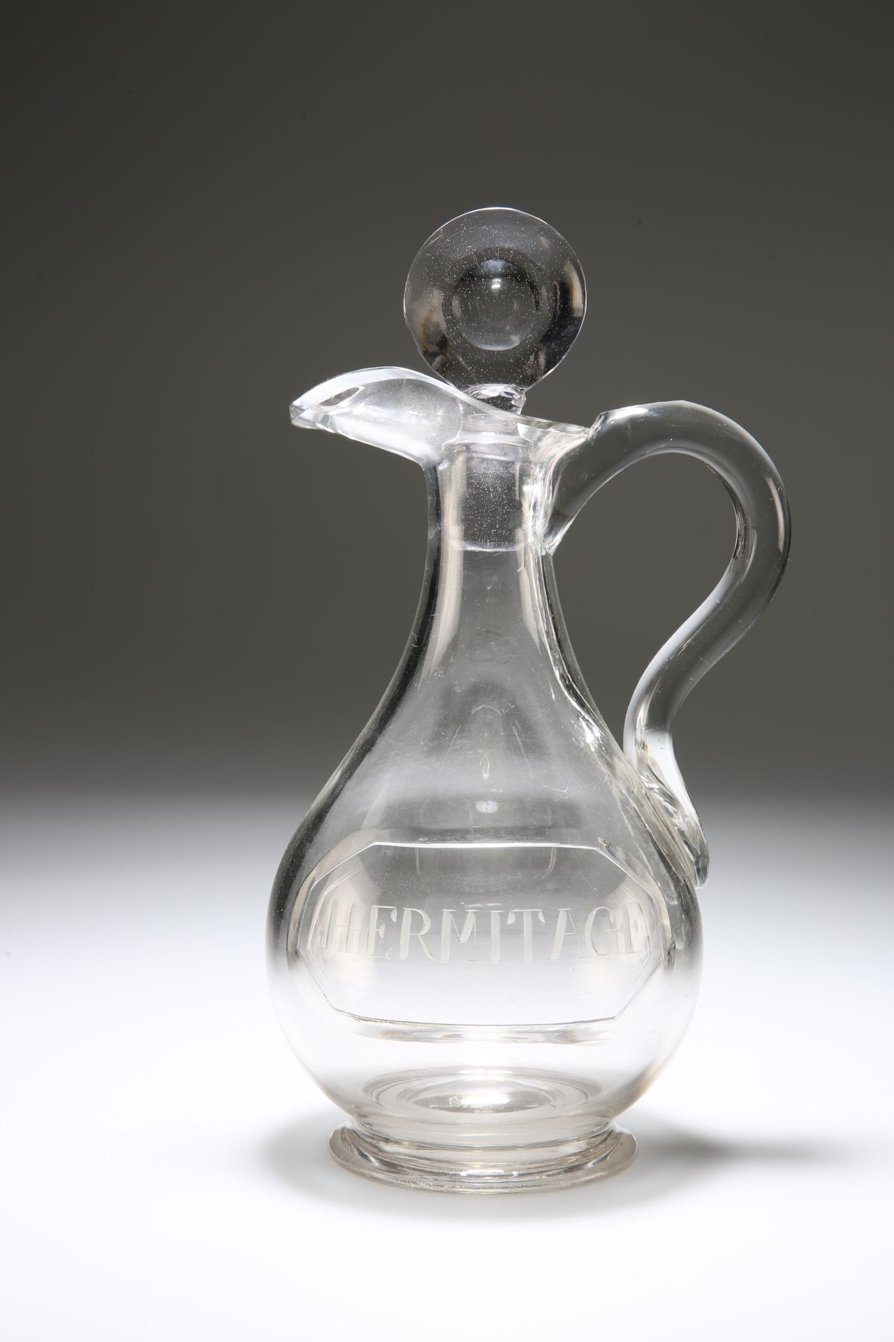 A GEORGE III GLASS CLARET JUG