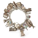 A CHARM BRACELET, charms include lighthouse, articulated fish, compass