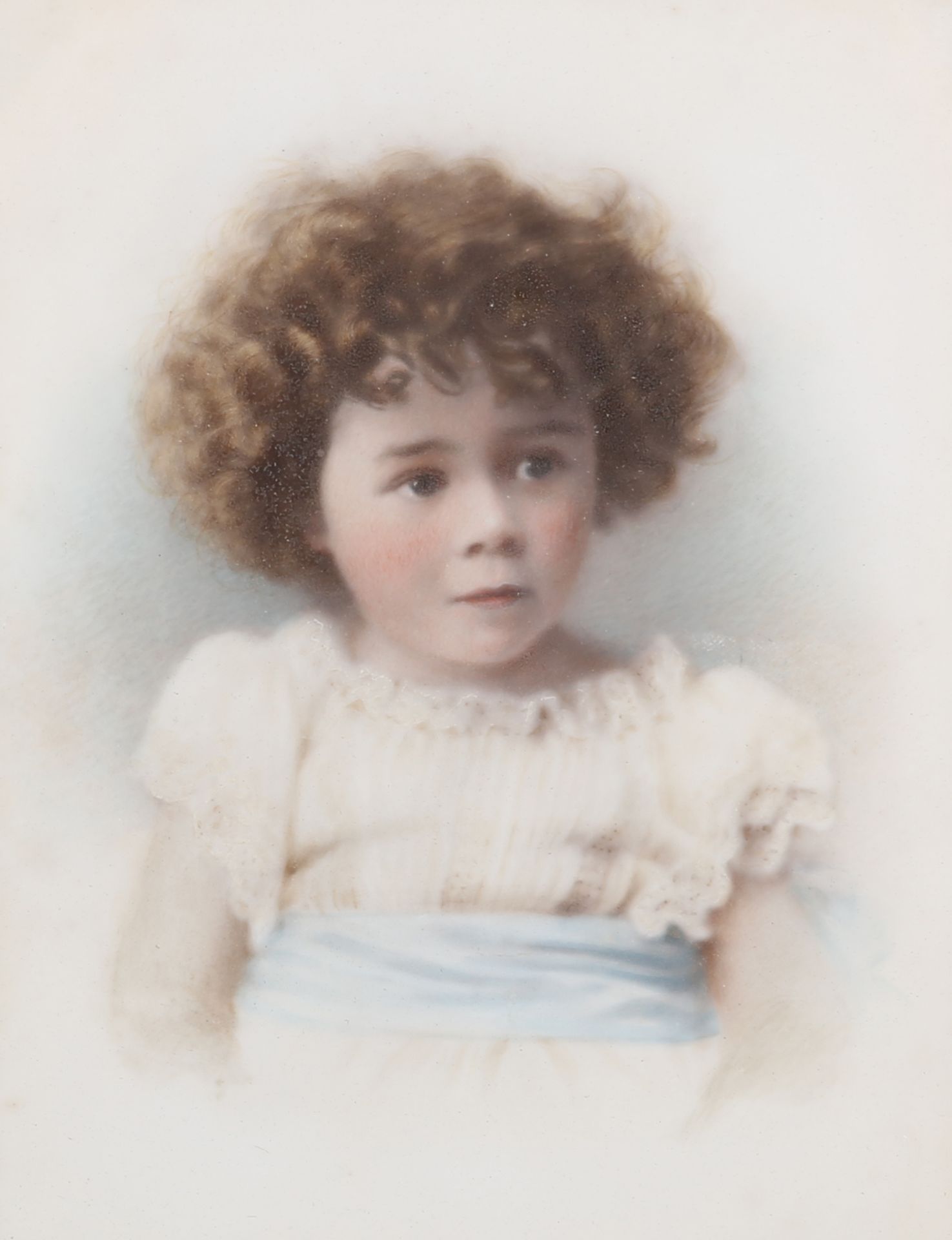 AN EDWARDIAN COLOURED PHOTOGRAPHIC PORTRAIT OF A CHILD