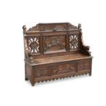 A LATE 19TH CENTURY CARVED OAK SETTLE