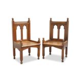 A LARGE PAIR OF 19TH CENTURY "GOTHIC" OAK HALL CHAIRS