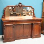 A VICTORIAN MAHOGANY FOUR-DOOR MIRROR-BACK CHIFFONIER, the mirror superstructure with leaf-carved