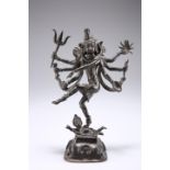 AN INDIAN BRONZE OF THE GODDESS KALI, modelled standing on a prostrate consort. 25cm