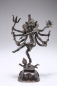 AN INDIAN BRONZE OF THE GODDESS KALI, modelled standing on a prostrate consort. 25cm