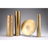 THREE BRASS SHELL CASES AND A SHELL CASE HEAD