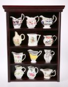 A SET OF TWELVE ROYAL WORCESTER "HISTORICAL COLLECTION" JUGS