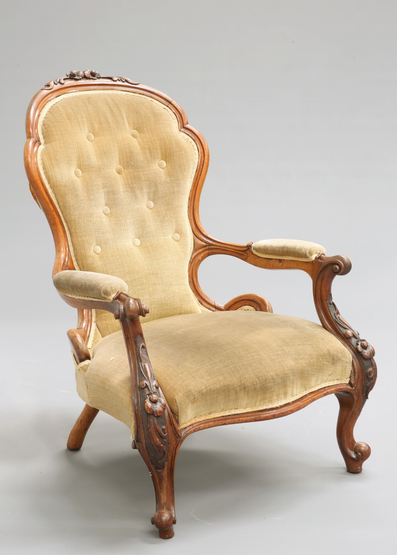 A VICTORIAN WALNUT ARMCHAIR