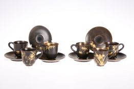 A SET OF JAPANESE LACQUERED AND GILDED PAPIER-MACHE COFFEE CUPS AND SAUCERS