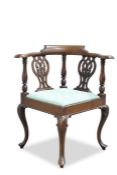 A GEORGE III STYLE MAHOGANY CORNER CHAIR