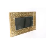 AN ARTS AND CRAFTS BRASS MIRROR