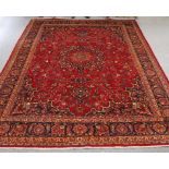 A LARGE PERSIAN HAND-KNOTTED CARPET