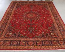 A LARGE PERSIAN HAND-KNOTTED CARPET